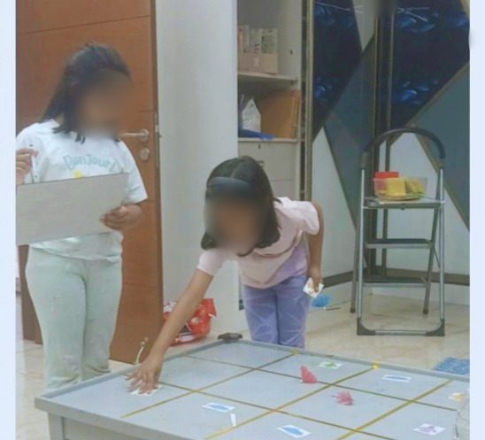 Children working on an unplugged coding grid activity