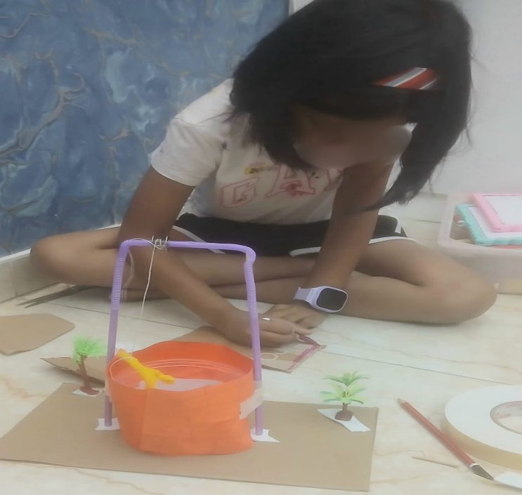 A child building and testing a flood barrier model