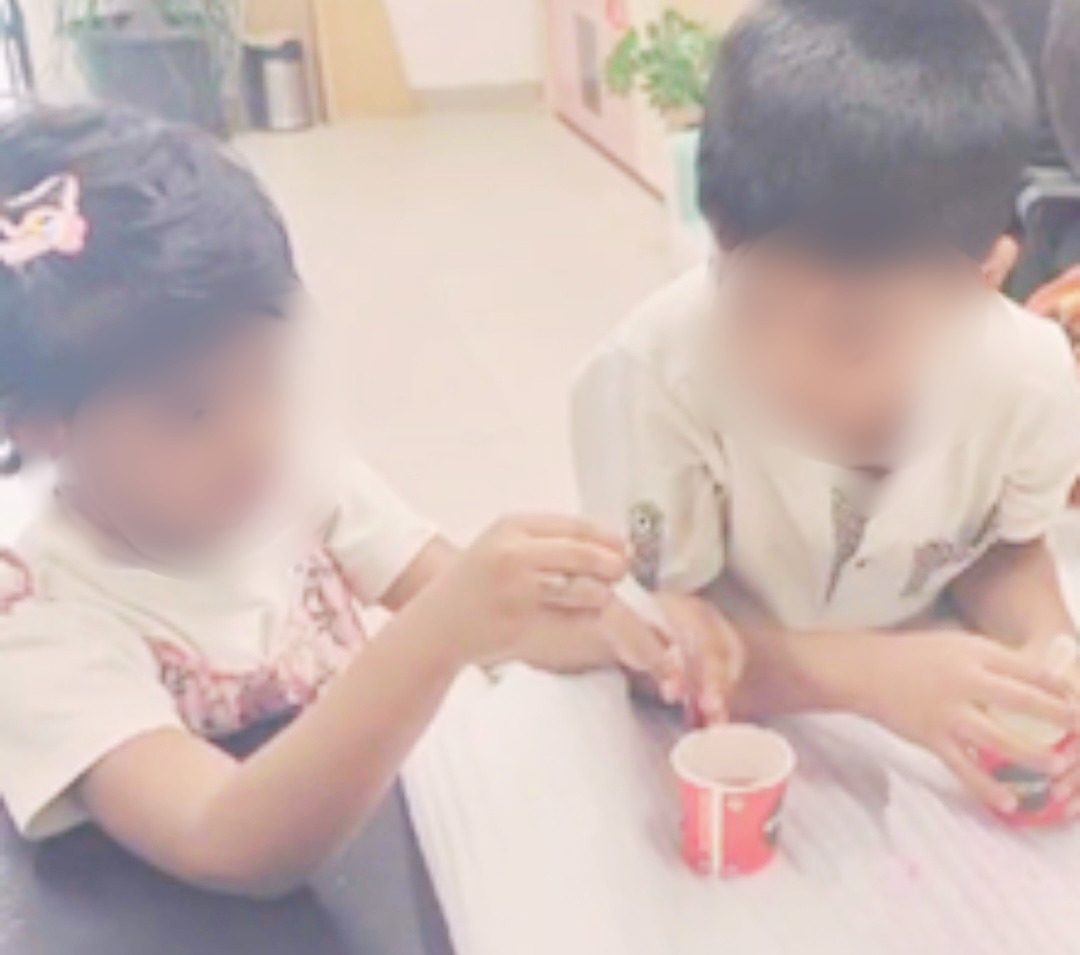 Two children carefully running a science experiment together